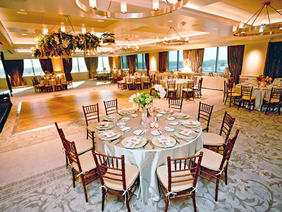 The Great Room, set up with dining tables, a buffet table with an ice sculpture, and a dance floor.