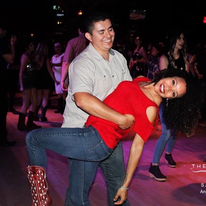 A couple doing a dip on a dance floor.