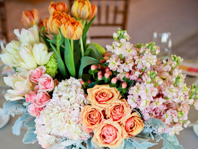 A close up of a rose and tulip bouquet.