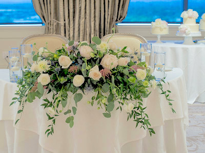 A close up of the flowers decorating the bride and groom's table.