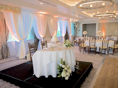 A side view of the bride and groom's table, decorated with roses.