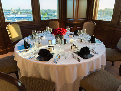 A set table by the window of the Hospitality Suite.